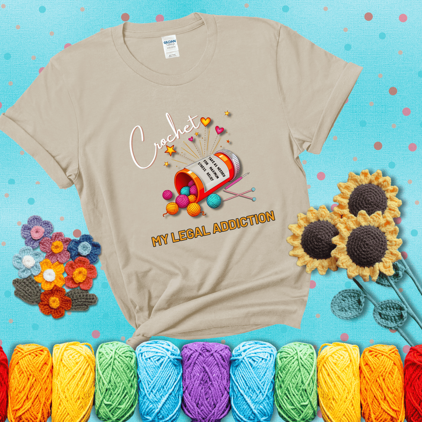 Orange prescription bottle spilling colorful yarn balls with text "Crochet – My Legal Addiction" and "Take as needed for maximum stress relief" showing a beige tee with a teal sunflower background