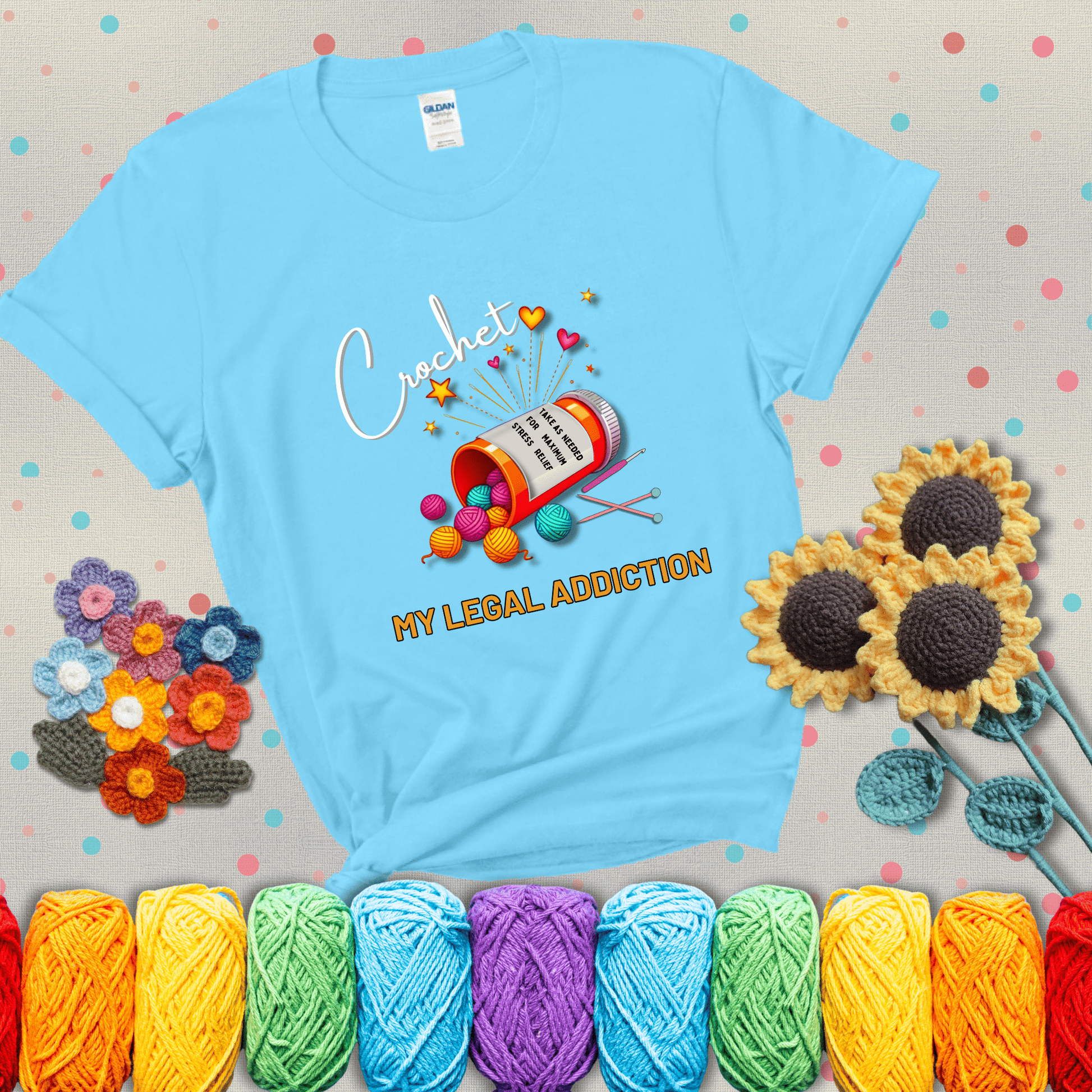 Orange prescription bottle spilling colorful yarn balls with text "Crochet – My Legal Addiction" and "Take as needed for maximum stress relief" showing a light blue tee with grey sunflower background