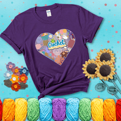 A heart filled with colorful crochet essentials including yarn, hooks, scissors, notions, and handmade items, with the word "Crochet" prominently in the center, showing a purple tee with a teal sunflower background
