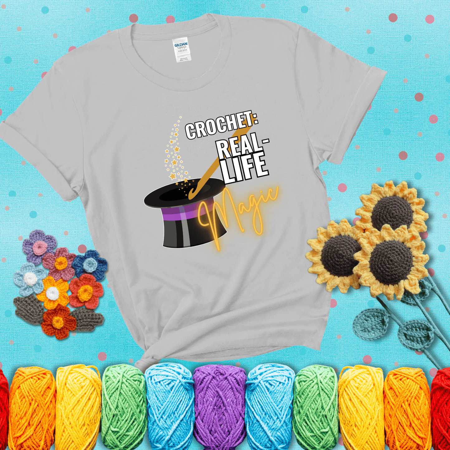 Poof! Stress gone Design reads 'Crochet: Real-Life Magic' , perfect crochet gift for yarn lovers; showing a light grey tee with a teal sunflower background