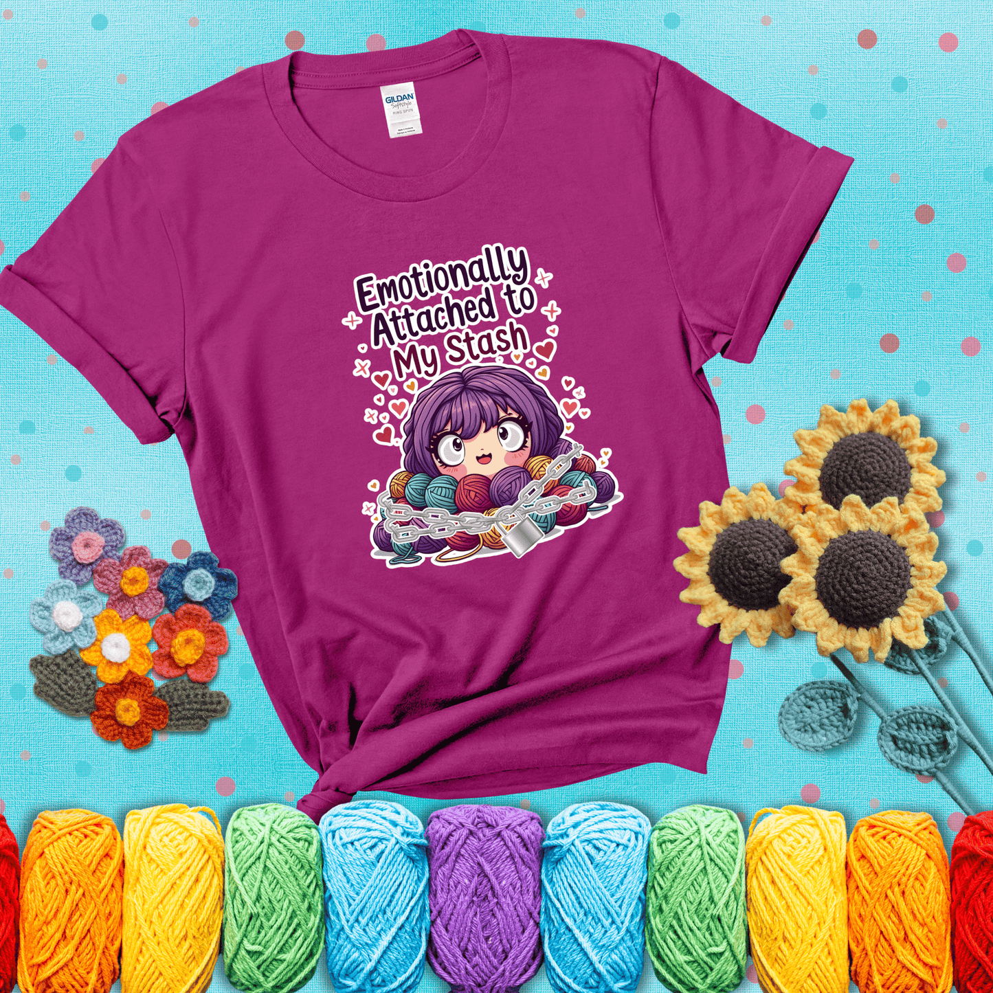 Rows of colorful yarn skeins stacked with playful text. Text reads: “Emotionally Attached to My Stash.” A humorous shirt for fiber lovers with growing collections, showing a magenta tee with a teal sunflower background