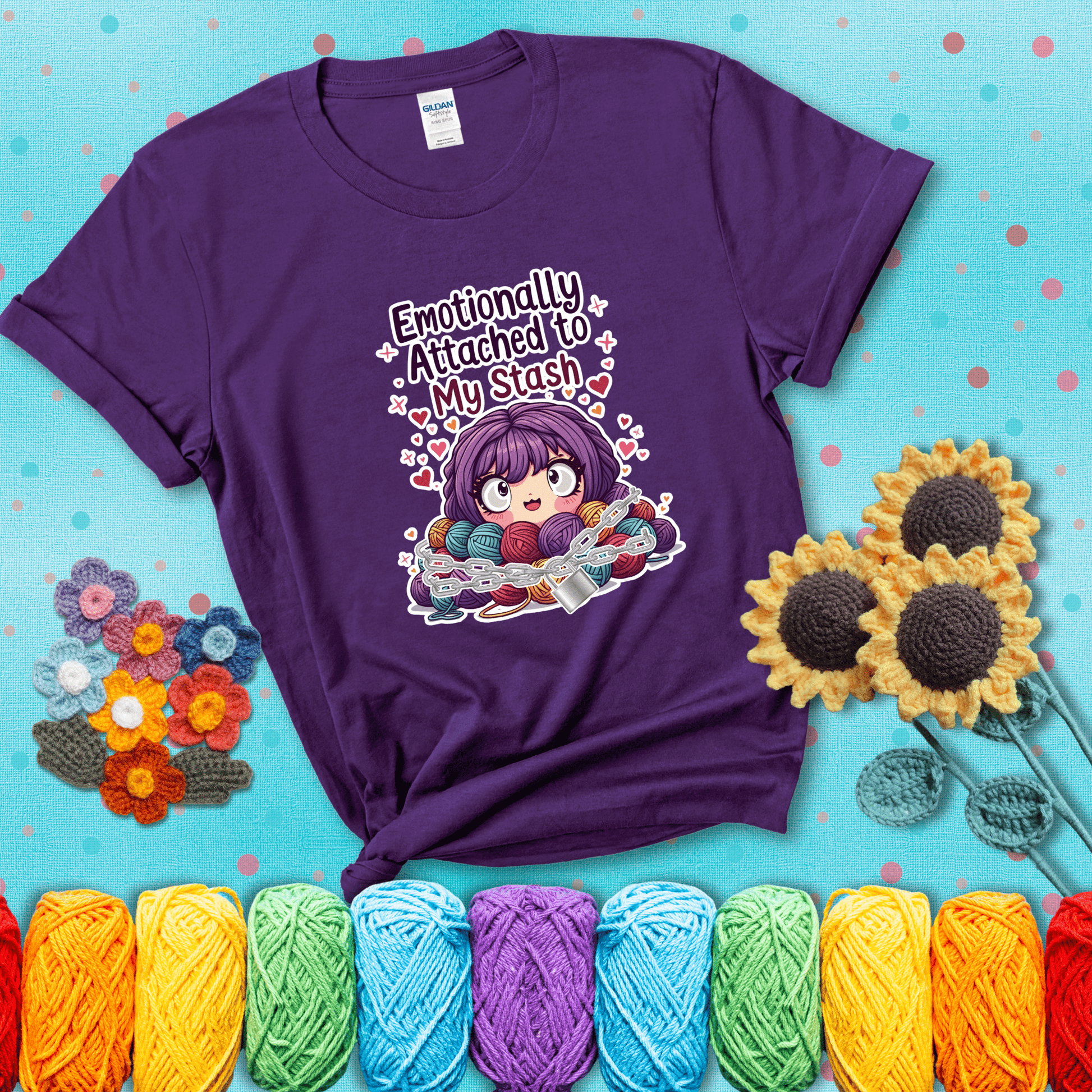 Rows of colorful yarn skeins stacked with playful text. Text reads: “Emotionally Attached to My Stash.” A humorous shirt for fiber lovers with growing collections, showing a purple tee with a teal sunflower background