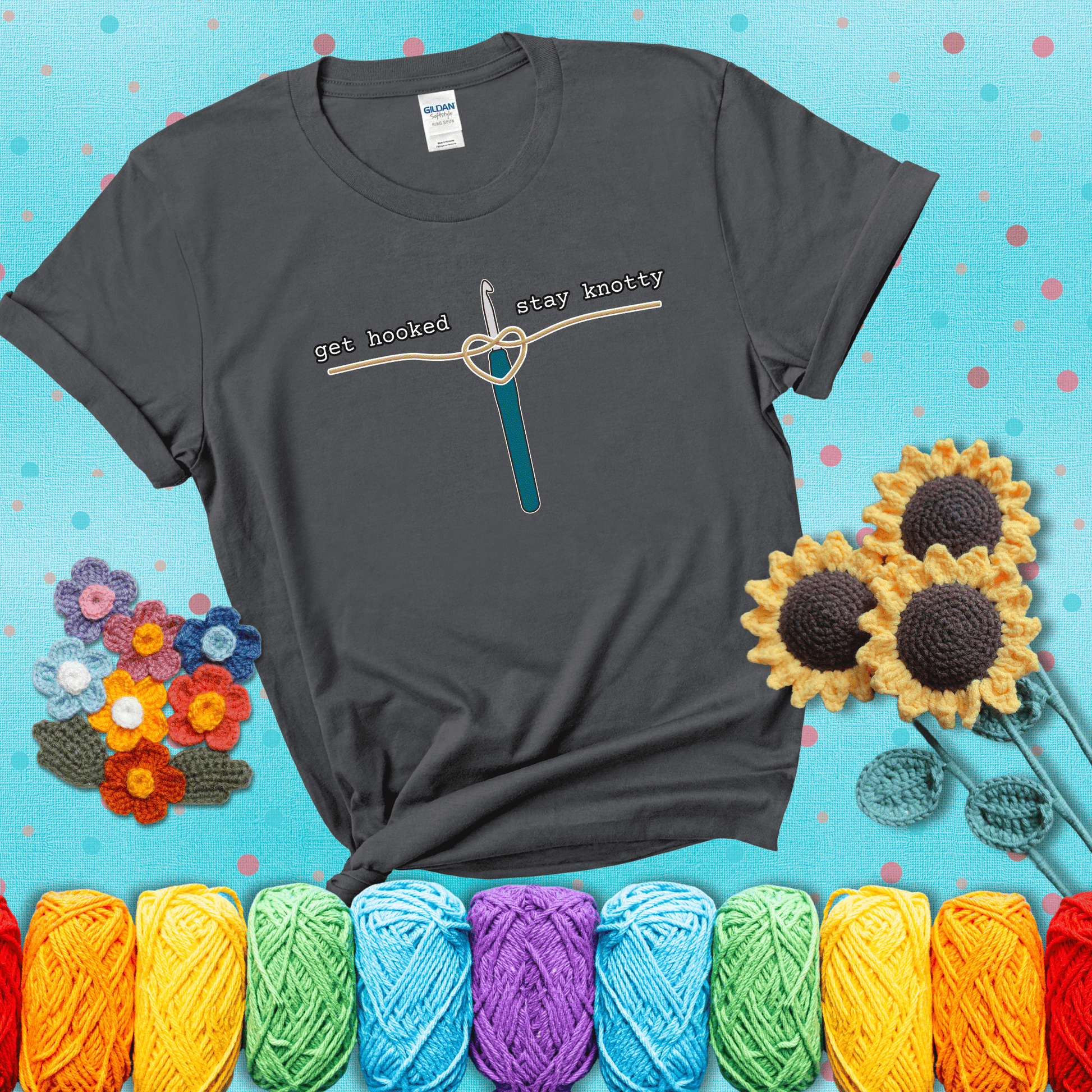 Hooked on yarn? Same Design reads 'Get Hooked, Stay Knotty' , perfect crochet gift for yarn lovers, showing a dark grey tee with a teal sunflower background