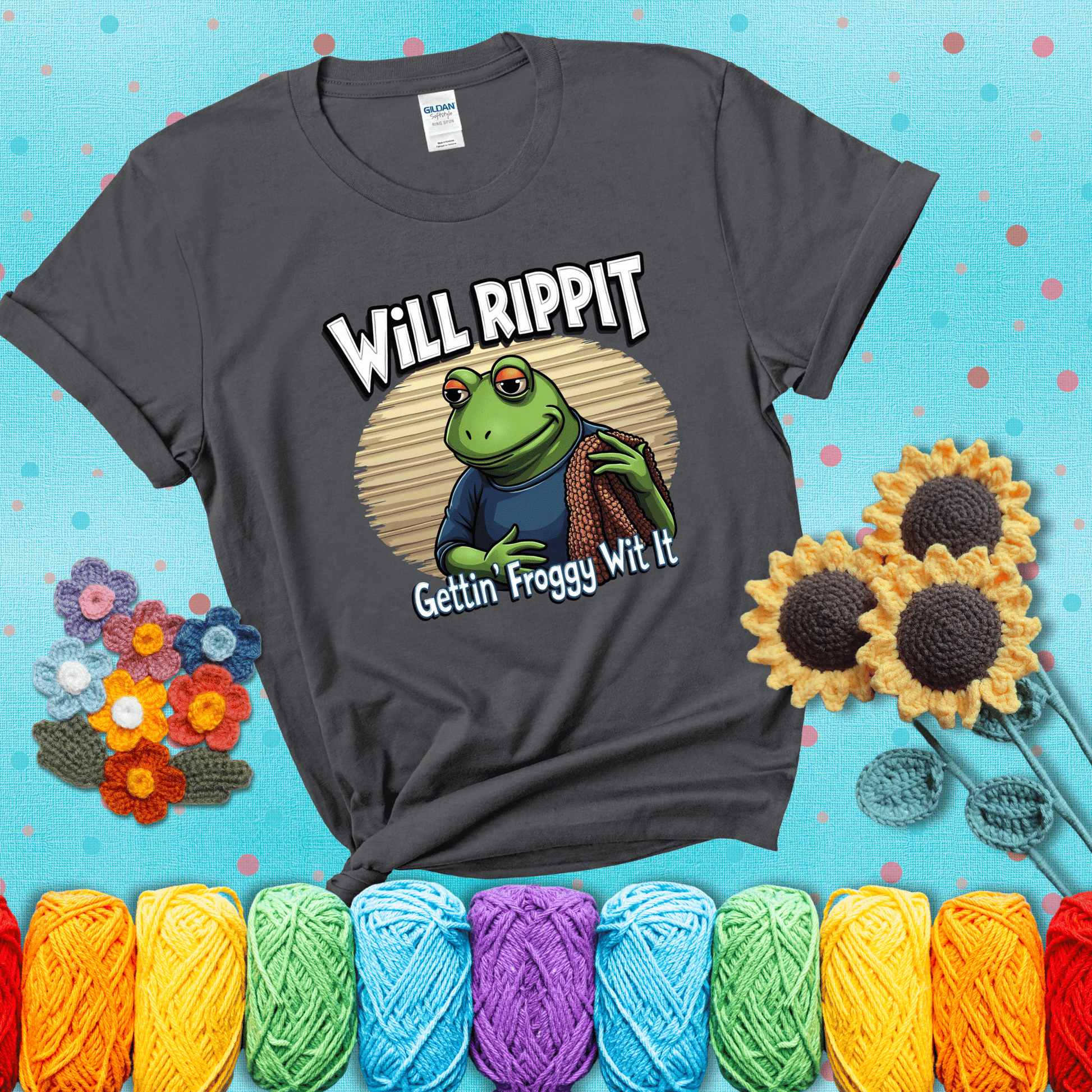Cool frog with sunglasses, surrounded by yarn and hooks. Text reads: “Gettin’ Froggy Wit It.” A hip and humorous crochet tee for yarn lovers with rhythm, showing a dark grey tee with a teal sunflower background
