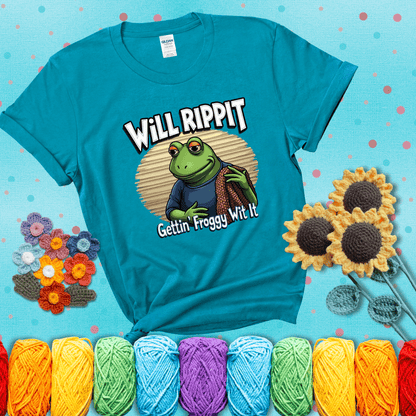 Cool frog with sunglasses, surrounded by yarn and hooks. Text reads: “Gettin’ Froggy Wit It.” A hip and humorous crochet tee for yarn lovers with rhythm, showing a blue-green tee with a teal sunflower background