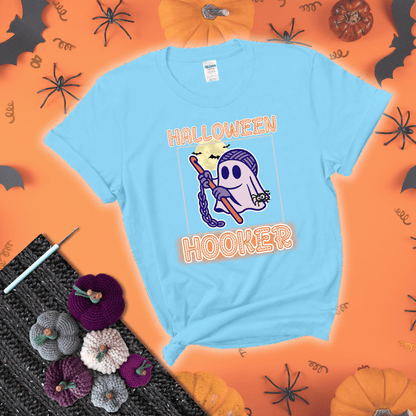 Cartoon ghost crocheter with a yarn ball head, crochet hook, bats, and text “Halloween Hooker,” a fun spooky tee for yarn lovers showing a light blue tee with a festive Halloween background