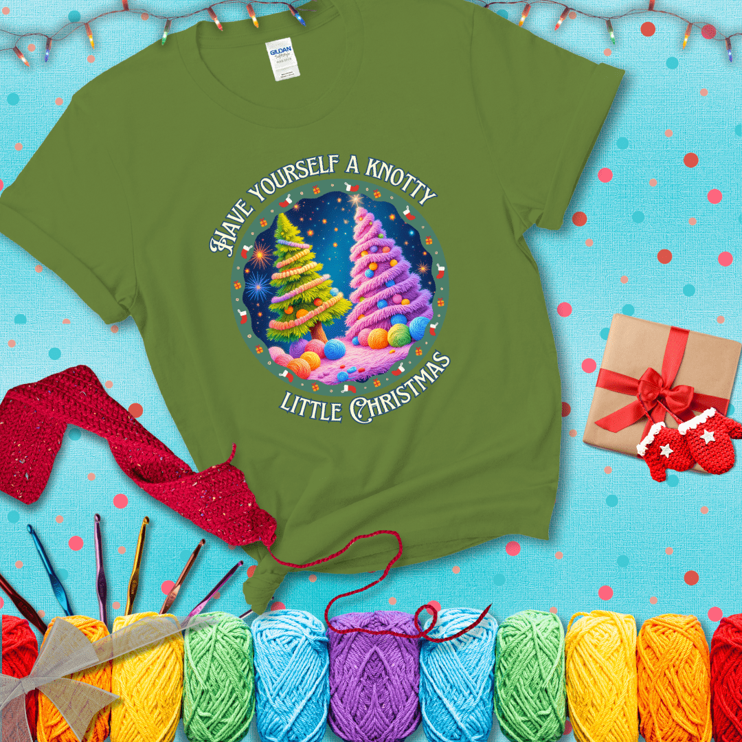 Two yarn-covered Christmas trees wrapped in colorful strands of yarn, with the phrase "Have Yourself a Knotty Little Christmas" encircling the scene showing a bright green tee with a festive Christmas background