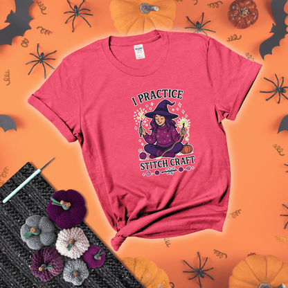 Witchy crocheter sits cross-legged, conjuring yarn magic with crochet hooks and glowing green yarn, surrounded by stars, pumpkins, and stitchy vibes showing a light red tee with a festive Halloween background