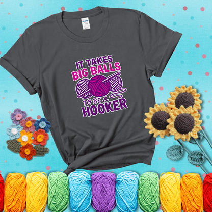 Bigger yarn, bolder energy Design reads 'It Takes Big Balls To Be A Hooker' , perfect crochet gift for yarn lovers showing a dark grey tee with a teal sunflower background