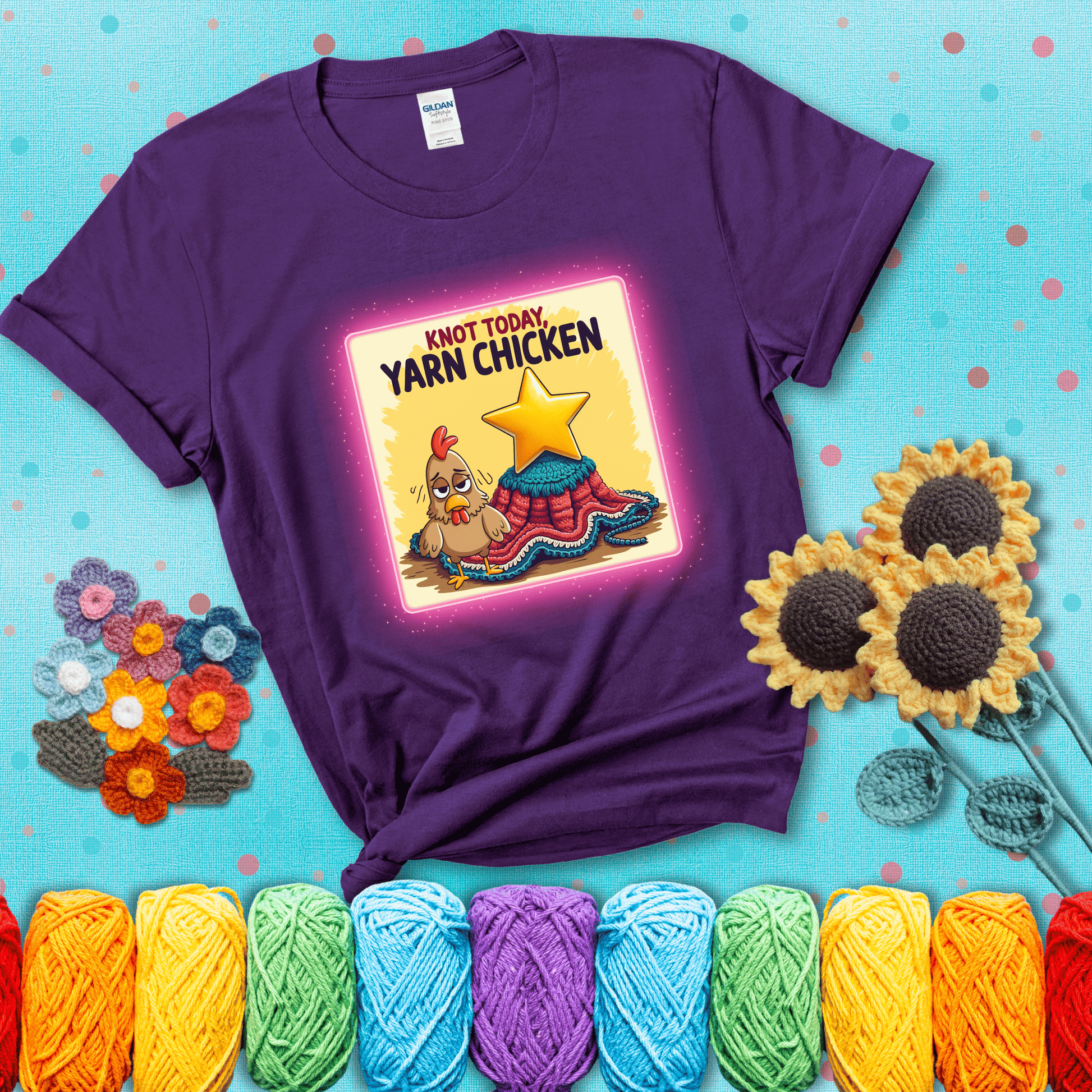 A frazzled cartoon chicken stands next to a nearly-finished project with minimal yarn left, with the phrase “Knot Today, Yarn Chicken” above, showing a purple tee with a teal sunflower background