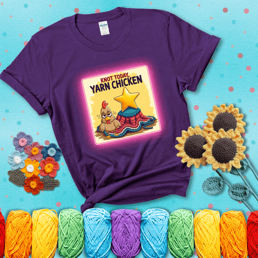 A frazzled cartoon chicken stands next to a nearly-finished project with minimal yarn left, with the phrase “Knot Today, Yarn Chicken” above, showing a purple tee with a teal sunflower background
