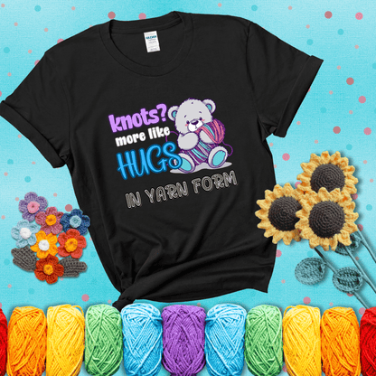 Cute teddy bear holding colorful yarn ball with hearts. Text reads: “Knots? More Like Hugs in Yarn Form.” Perfect for cozy gift-givers and yarn lovers, showing a black tee with a teal sunflower background