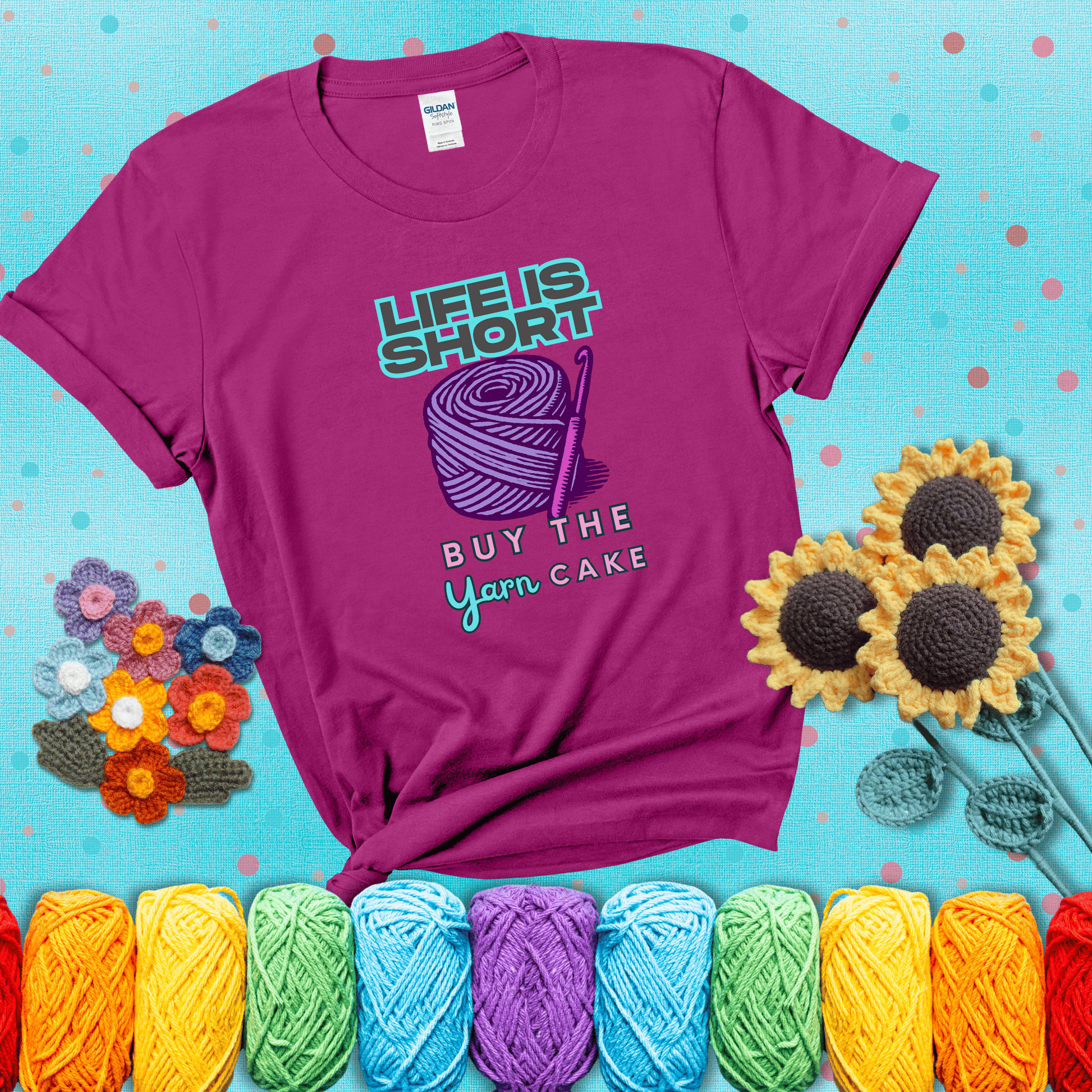 No regrets, just yarn Design reads 'Life Is Short. Buy The Yarn (Cake)' , perfect crochet gift for yarn lovers, showing a magenta tee with a teal sunflower background
