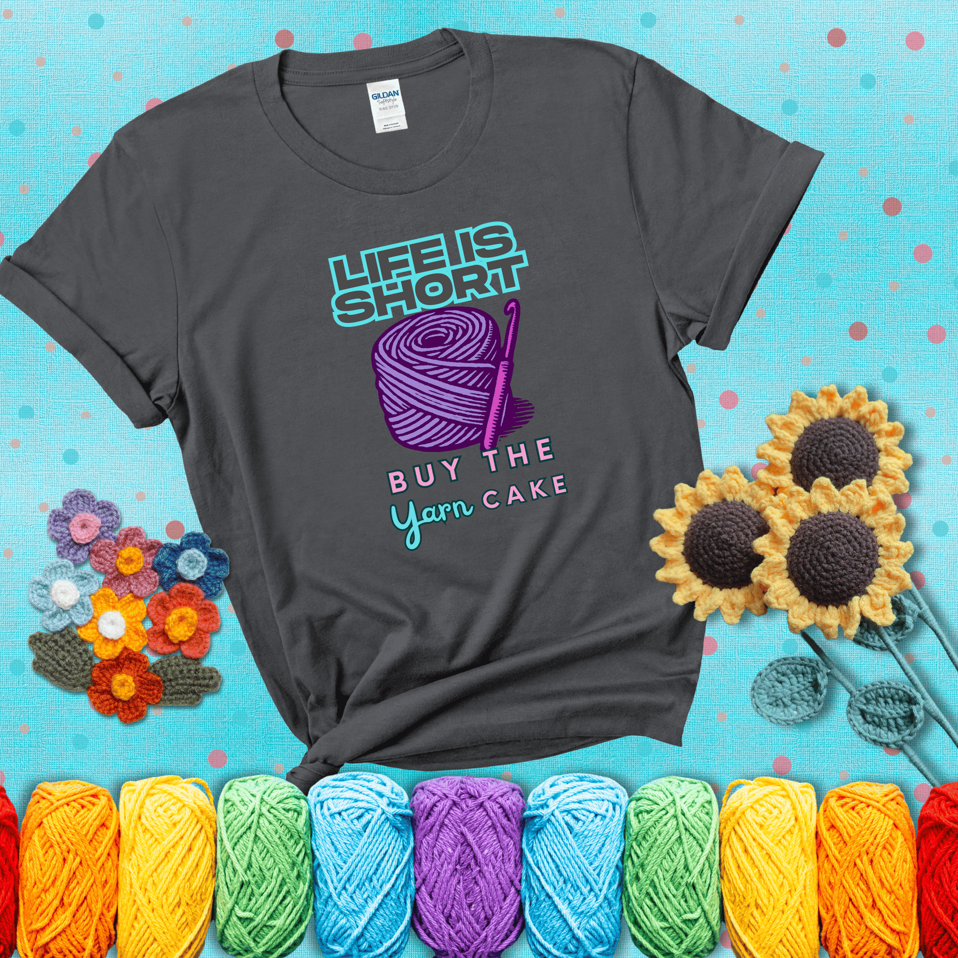 No regrets, just yarn Design reads 'Life Is Short. Buy The Yarn (Cake)' , perfect crochet gift for yarn lovers, showing a dark grey tee with a teal sunflower background