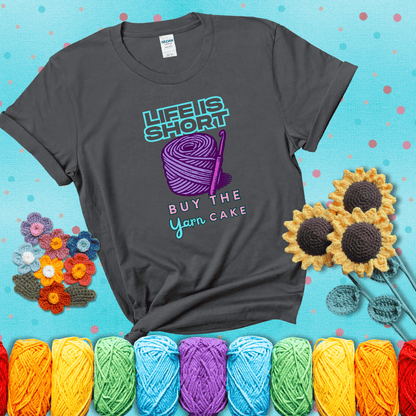 No regrets, just yarn Design reads 'Life Is Short. Buy The Yarn (Cake)' , perfect crochet gift for yarn lovers, showing a dark grey tee with a teal sunflower background