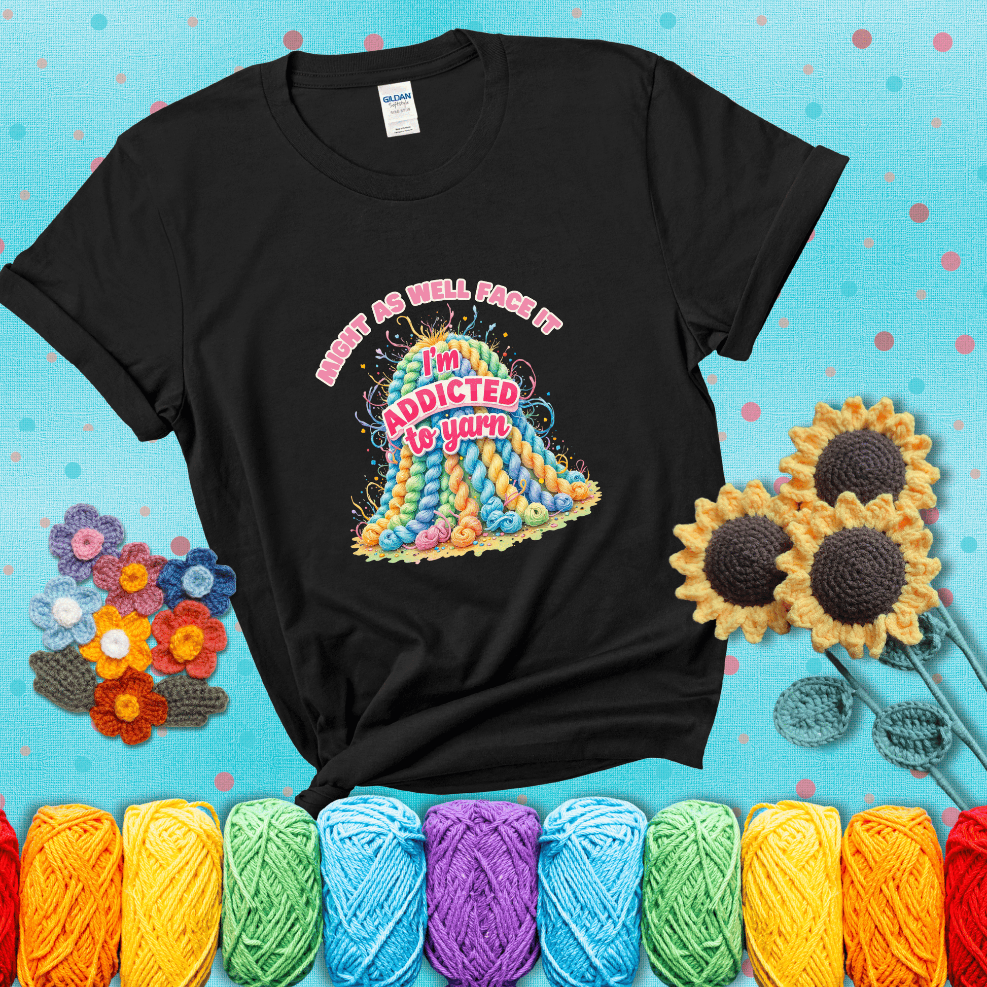 Colorful mountain of pastel yarn hanks with the phrase “Might as well face it, I’m addicted to yarn” in playful pink and red lettering showing a black tee with a teal sunflower background