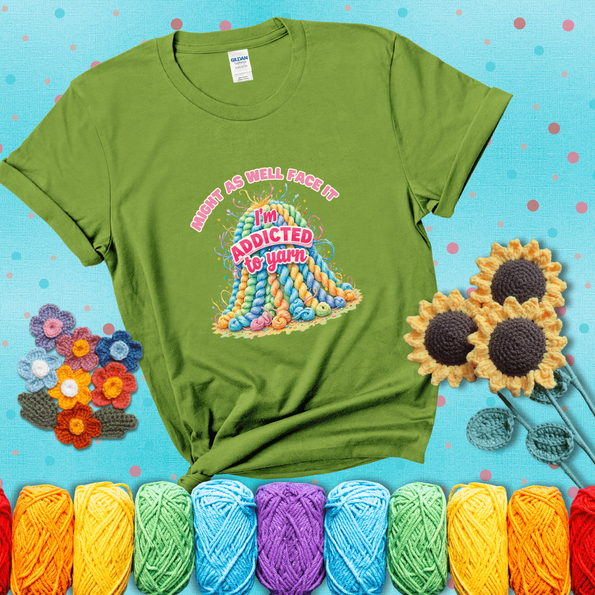 Colorful mountain of pastel yarn hanks with the phrase “Might as well face it, I’m addicted to yarn” in playful pink and red lettering showing a bright green tee with a teal sunflower background