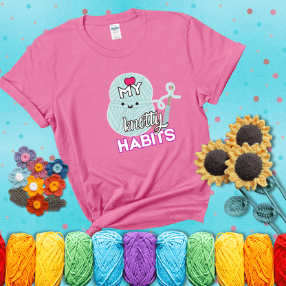Smiling yarn ball and hook with text “Love My Knotty Habits” - cute crochet shirt with playful design for makers, showing a pink tee with a teal sunflower background
