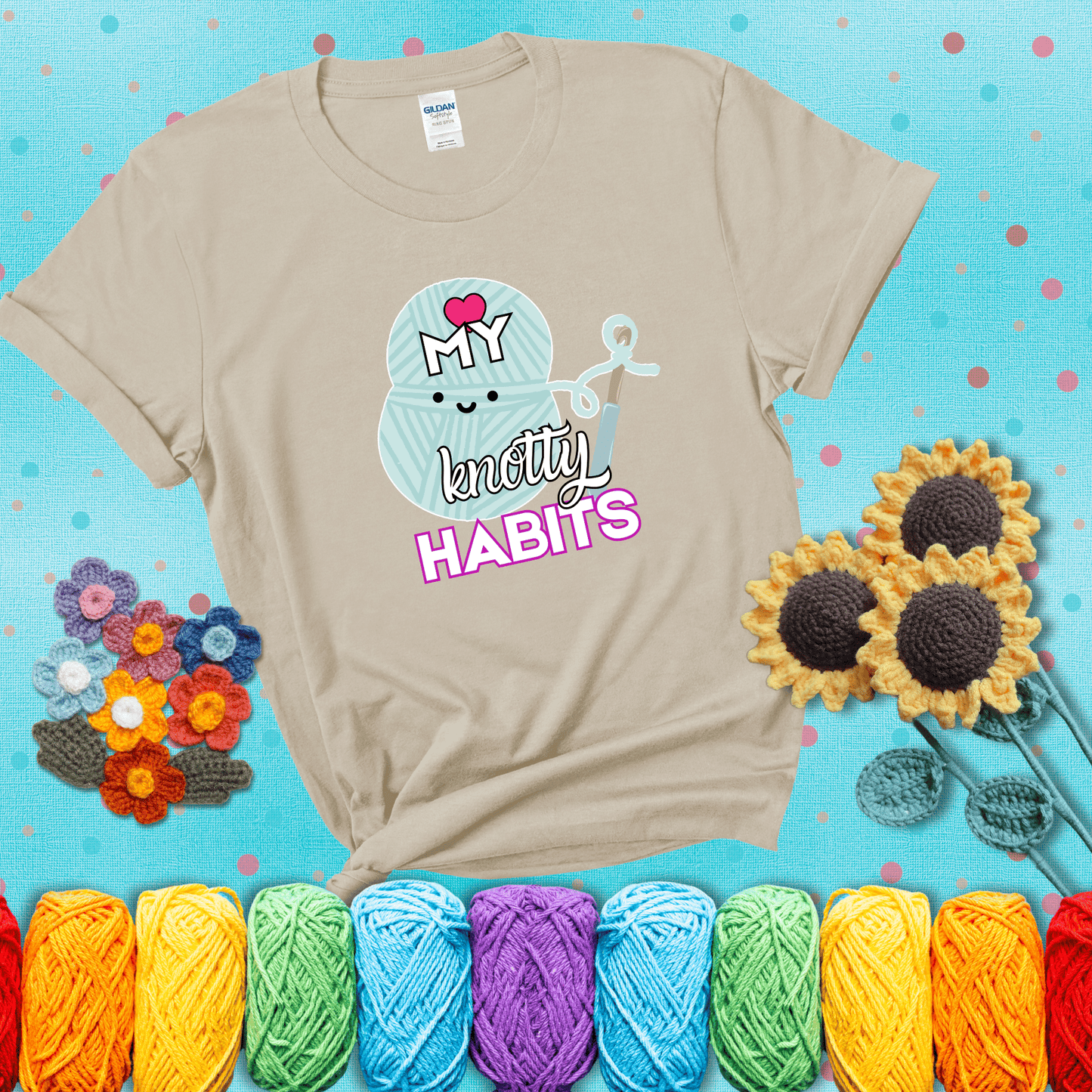 Smiling yarn ball and hook with text “Love My Knotty Habits” - cute crochet shirt with playful design for makers, showing a beige tee with a teal sunflower background