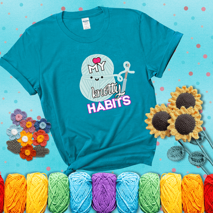 Smiling yarn ball and hook with text “Love My Knotty Habits” - cute crochet shirt with playful design for makers, showing a blue-green tee with a teal sunflower background