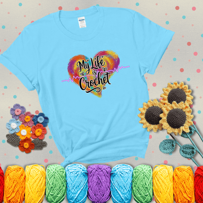 Colorful heart with an EKG line and text: “My Life is Crochet” in bold script showing a light blue tee with grey sunflower background