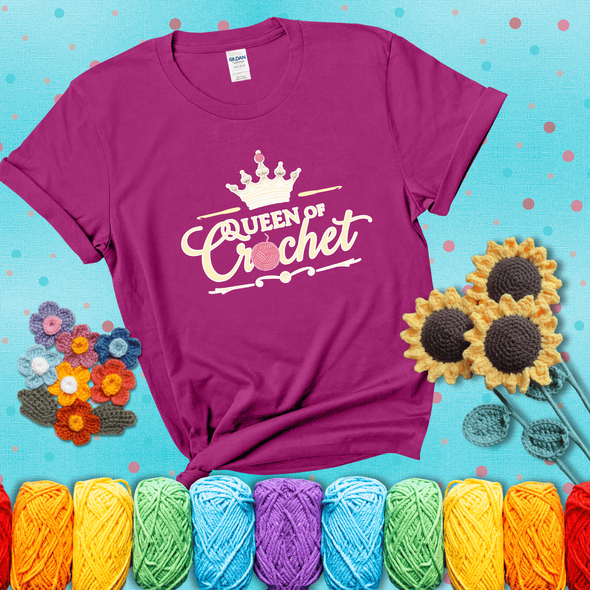 Crown-topped design reads “Queen of Crochet” with elegant script and two pink yarn balls, one forming the letter “o” and another atop the crown showing a magenta tee with a teal sunflower background
