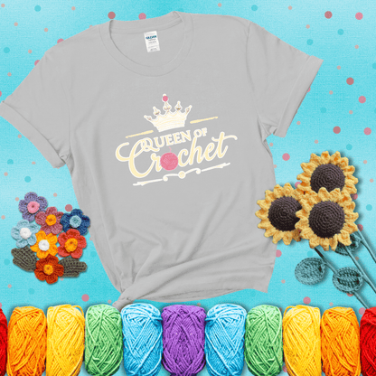Crown-topped design reads “Queen of Crochet” with elegant script and two pink yarn balls, one forming the letter “o” and another atop the crown showing a light grey tee with a teal sunflower background
