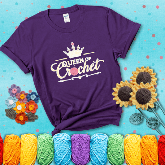 Crown-topped design reads “Queen of Crochet” with elegant script and two pink yarn balls, one forming the letter “o” and another atop the crown showing a purple tee with a teal sunflower background