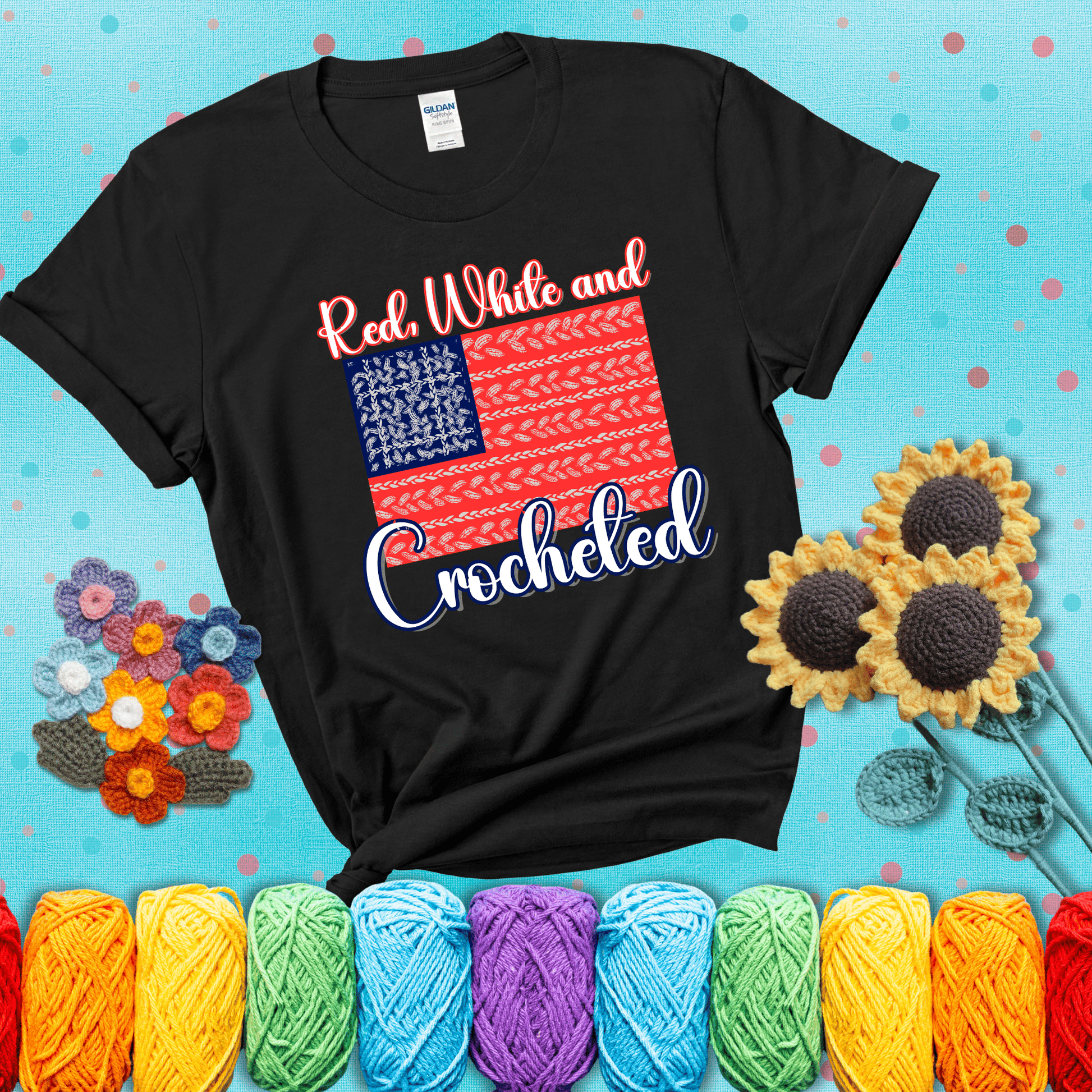 Patriotic crochet-themed American flag design with red and white yarn stitches forming the stripes and blue and white stitches as stars, showing a black tee with a teal sunflower background