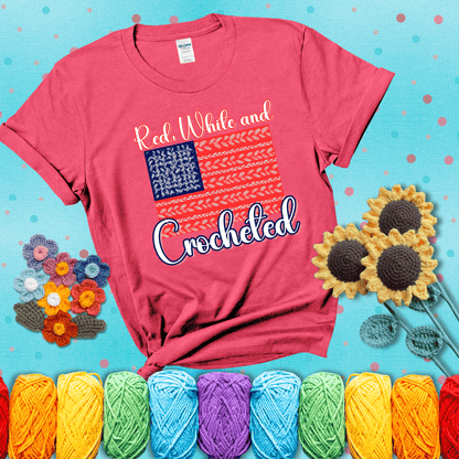 Patriotic crochet-themed American flag design with red and white yarn stitches forming the stripes and blue and white stitches as stars, showing a light red tee with a teal sunflower background