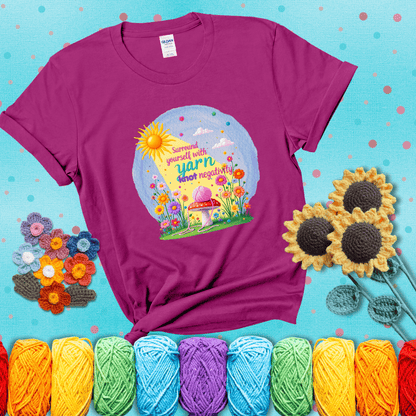 A happy spring garden scene with a sunbeam, flowers, and a pink yarn ball on a mushroom, with the quote "Surround yourself with yarn, knot negativity," showing a magenta tee with a teal sunflower background