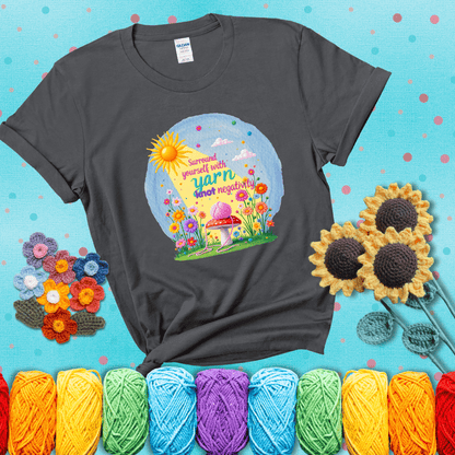 A happy spring garden scene with a sunbeam, flowers, and a pink yarn ball on a mushroom, with the quote "Surround yourself with yarn, knot negativity," showing a dark grey tee with a teal sunflower background