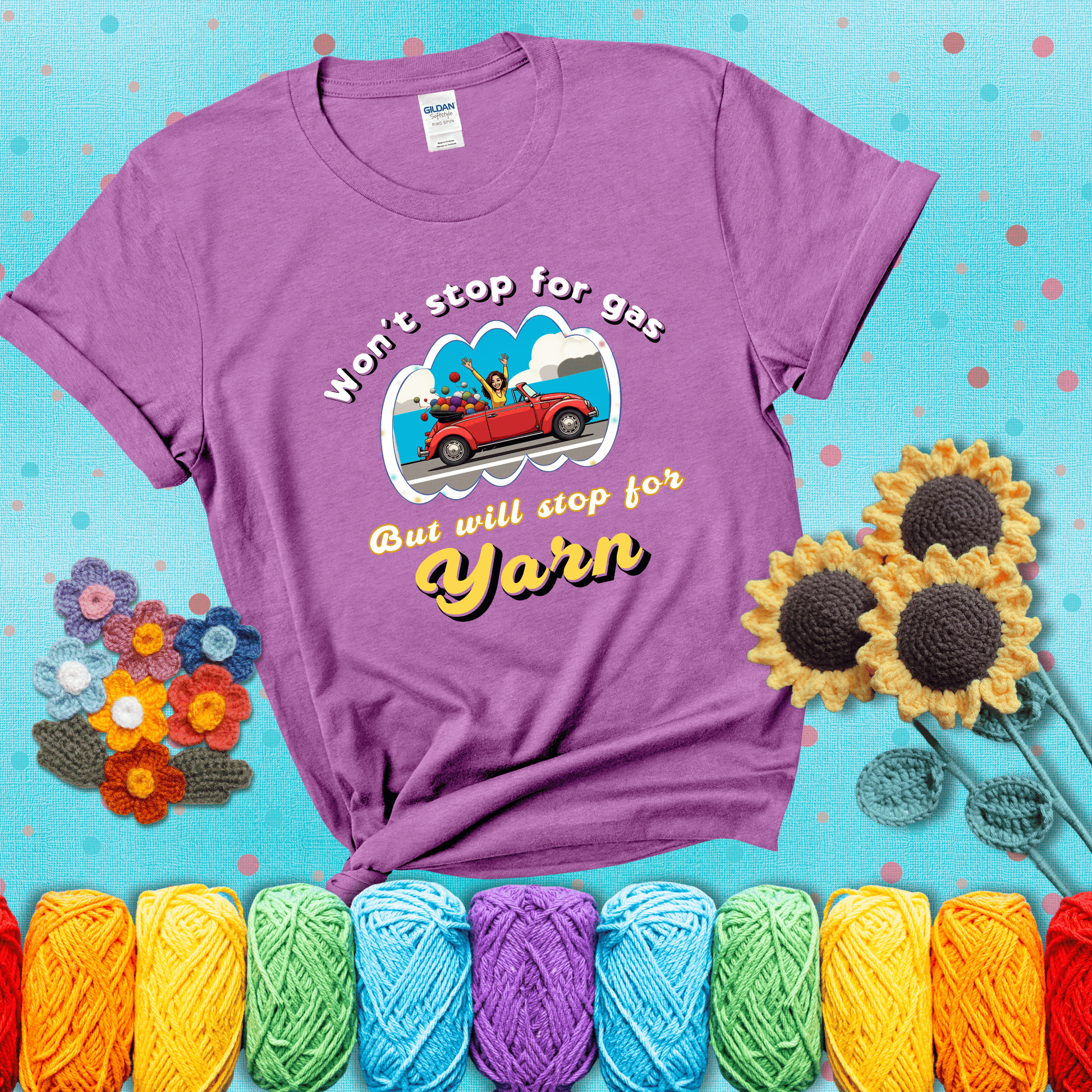 Woman joyfully driving a red convertible overflowing with yarn balls, paired with bold retro lettering and a playful slogan showing a light purple tee with a teal sunflower background