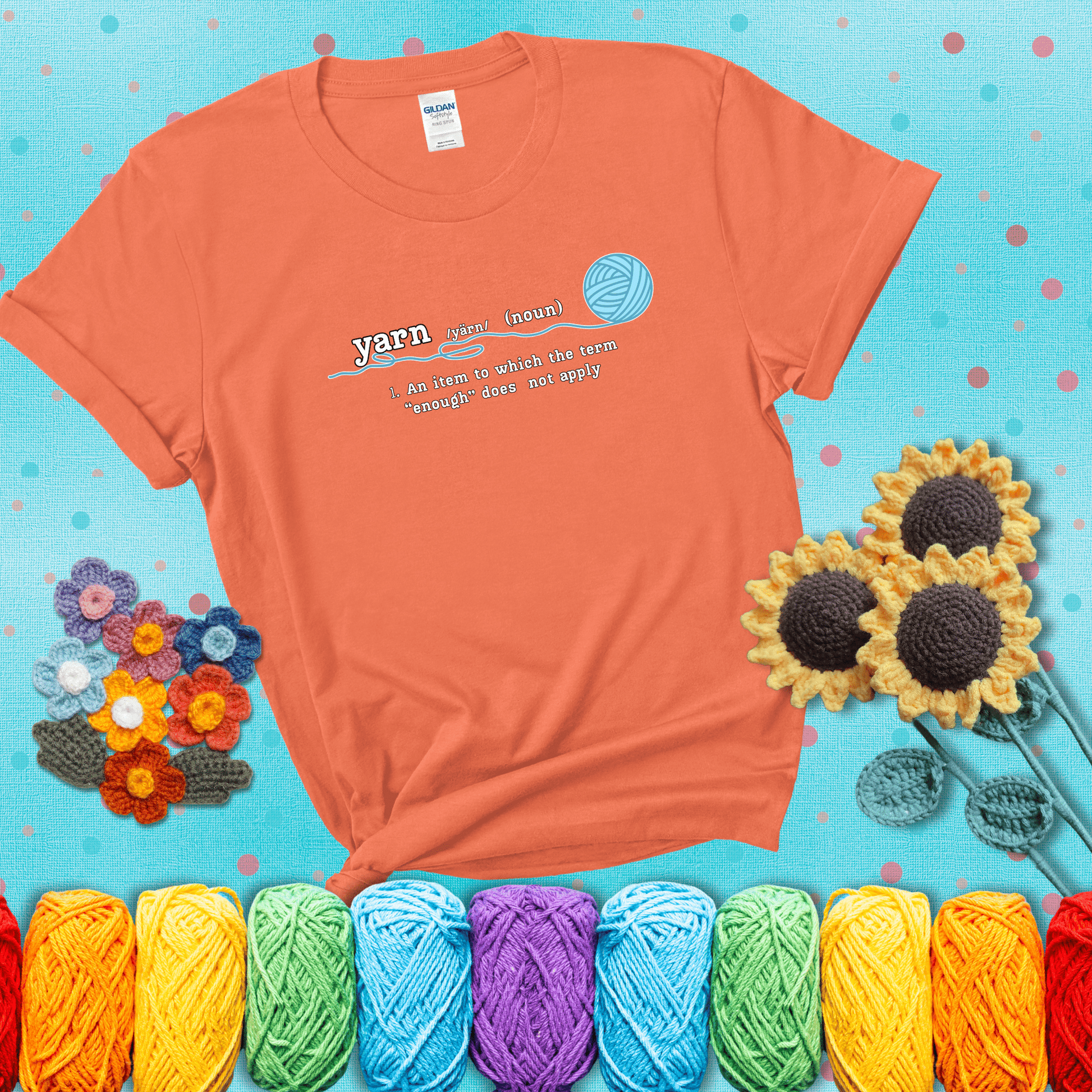 A definition-style graphic showing the word "yarn" as a noun, with the definition “An item to which the term ‘enough’ does not apply,” and a ball of blue yarn with a loose strand showing a light orange tee with a teal sunflower background
