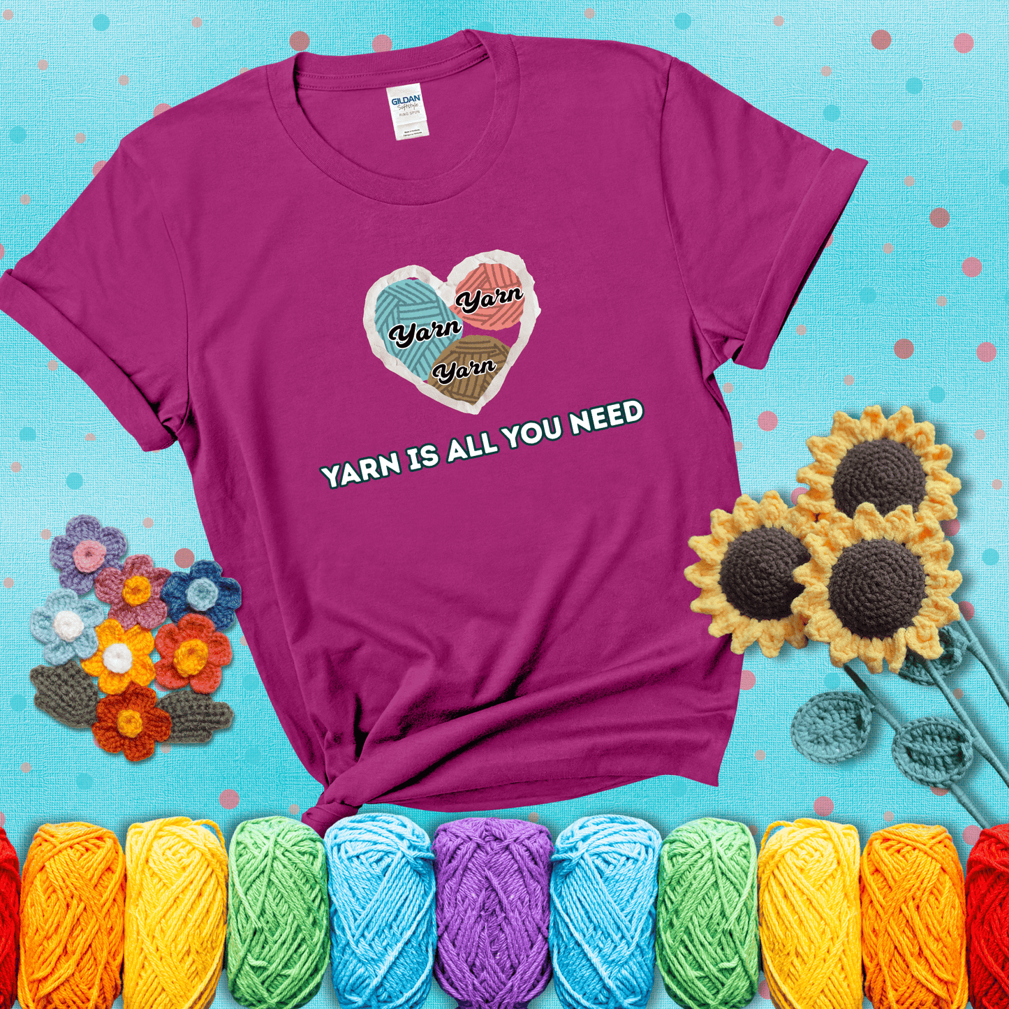 Heart made of yarn textures labeled “Yarn” in different colors above the phrase “Yarn is all you need” in bold retro type, showing a magenta tee with a teal sunflower background