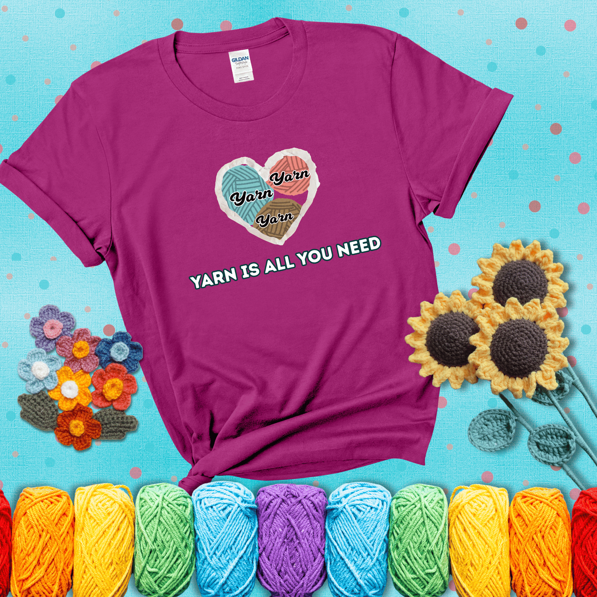 Heart made of yarn textures labeled “Yarn” in different colors above the phrase “Yarn is all you need” in bold retro type, showing a magenta tee with a teal sunflower background