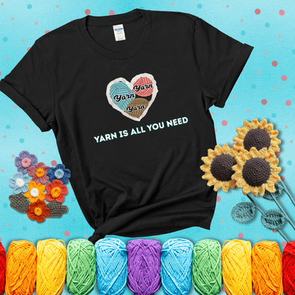 Heart made of yarn textures labeled “Yarn” in different colors above the phrase “Yarn is all you need” in bold retro type, showing a black tee with a teal sunflower background