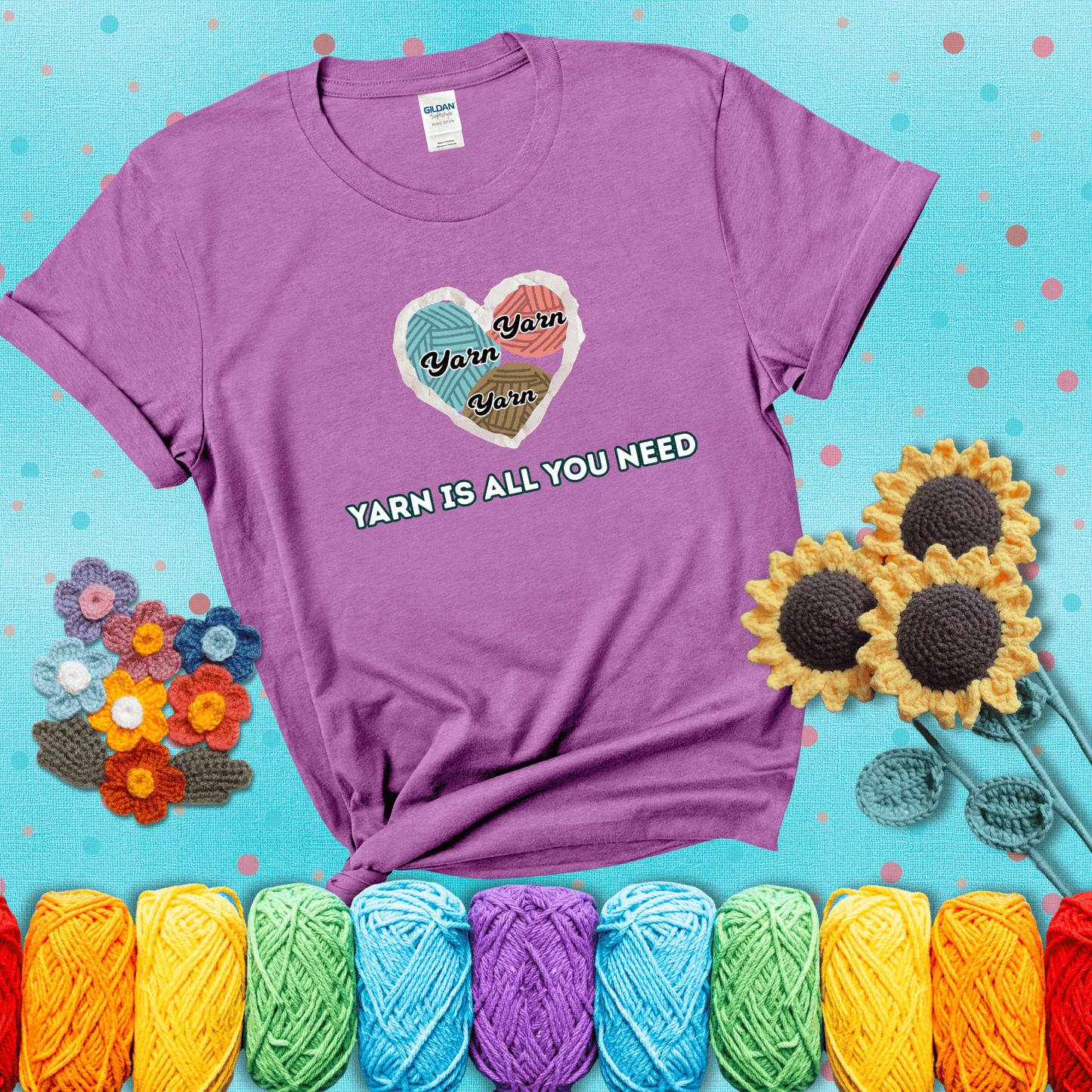 Heart made of yarn textures labeled “Yarn” in different colors above the phrase “Yarn is all you need” in bold retro type, showing a light purple tee with a teal sunflower background