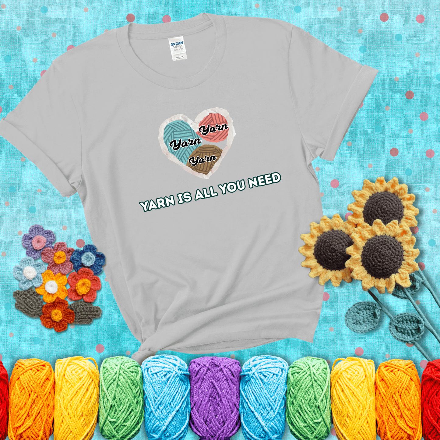 Heart made of yarn textures labeled “Yarn” in different colors above the phrase “Yarn is all you need” in bold retro type, showing a light grey tee with a teal sunflower background