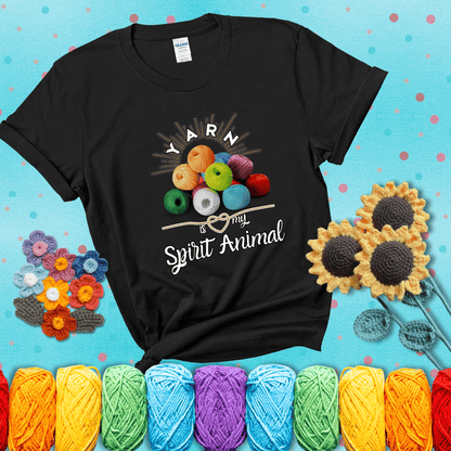 Stack of colorful yarn balls with radiant glow. Text reads: “Yarn Is My Spirit Animal.” A calming and colorful tee for fiber lovers who find zen in stitching, showing a black tee with a teal sunflower background