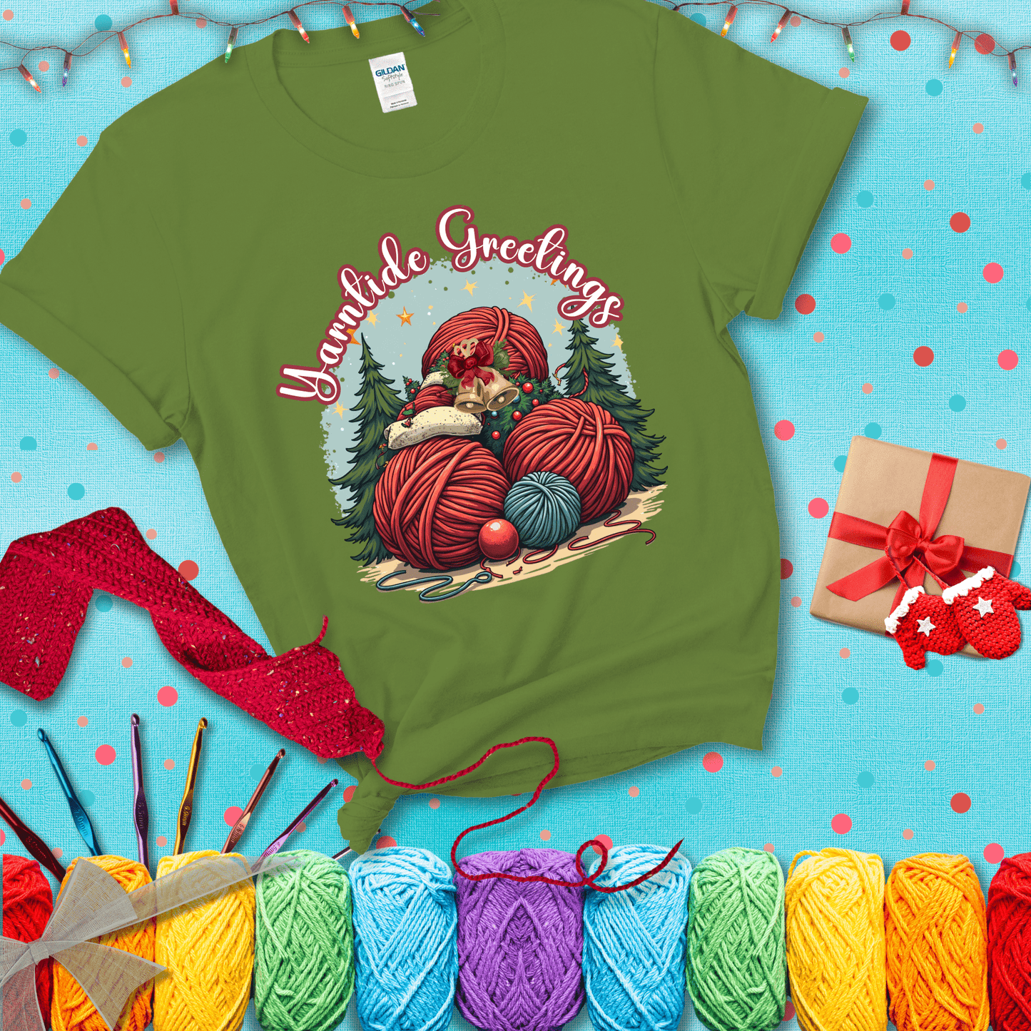 Pile of colorful yarn balls with bells, bows, and trees, with the phrase “Yarntide Greetings.” Cozy and festive holiday crochet tee, showing a bright green tee with a festive Christmas background